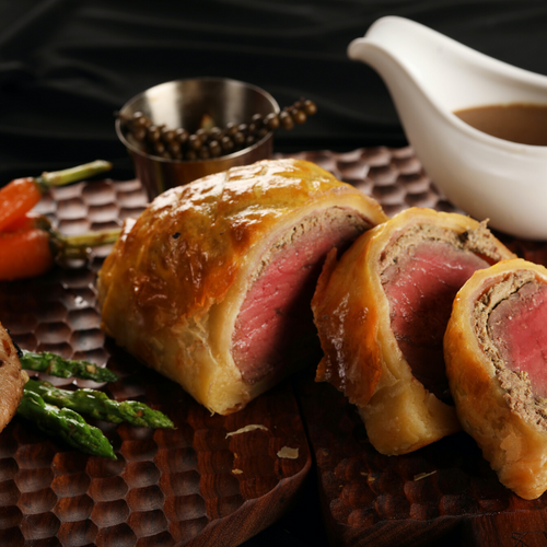 Beef Wellington wrapped in golden puff pastry