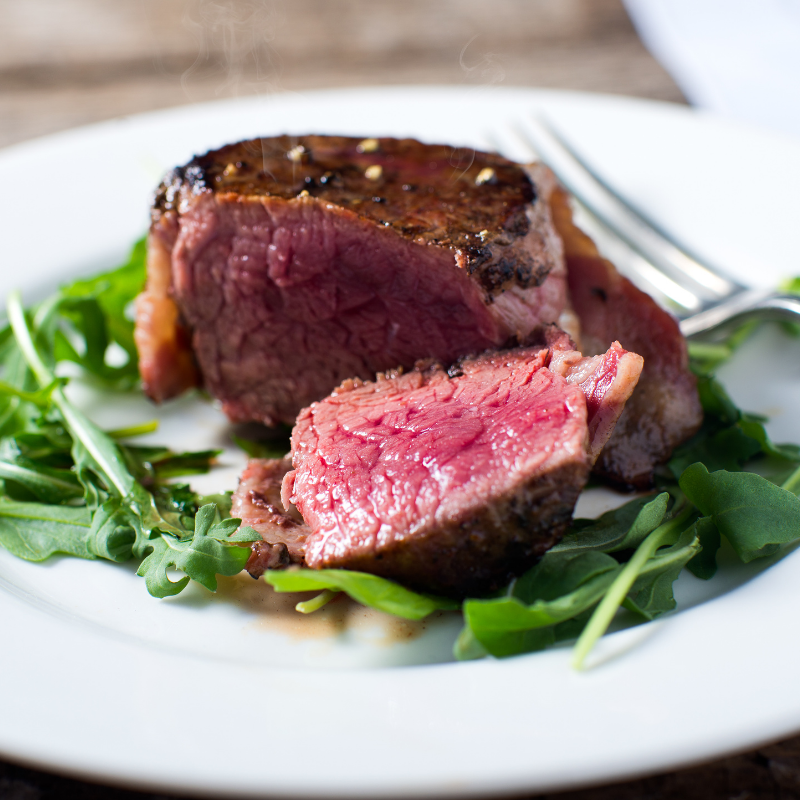 Raw hand-trimmed filet mignon steaks from aged tenderloin