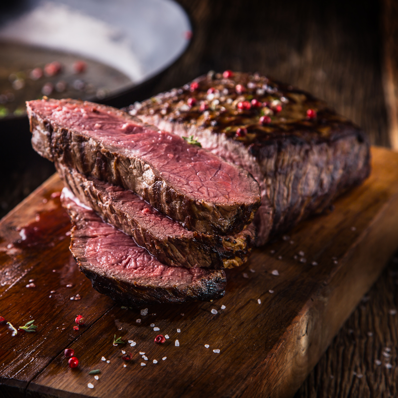 Cooked drop cut rib eye steak sliced and plated